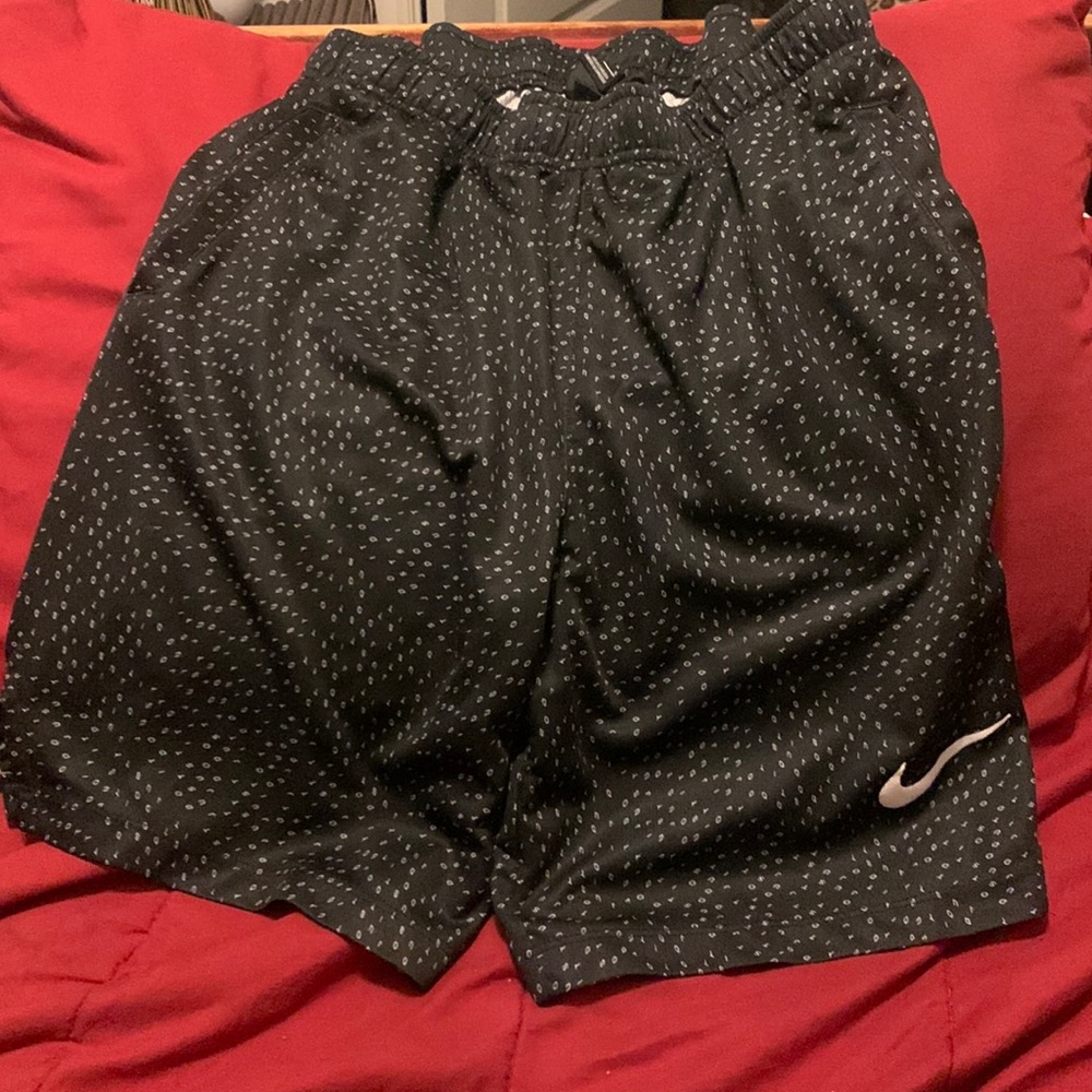 Boys black Nike shorts with just do it in small print all over